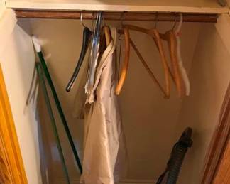 199 - Closet Lot (Description): Closet lot containing miscellaneous household  items including umbrellas, hangers, vacuum  cleaner, cleaning supplies, and assorted  items on shelf.