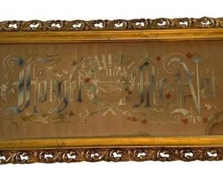 658 - Framed Needlepoint 26"x12" (Description): A framed needlepoint featuring decorative  lettering with floral and foliate  embellishments. The needlework is presented  in an ornate gilded frame with a gold inner  liner. Measures 26 inches by 12 inches.