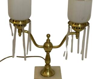 759 - Vintage Brass Double-Arm Table Lamp w/ prisms (Description): A decorative double-arm lamp featuring a  brass frame with two frosted glass shades and  hanging glass prisms. The lamp sits on a  marble base and measures 12.5 inches tall. Used as is electric/electronic/mechanical item. No guarantee all components, untested.