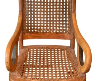 55 - Antique Rocker 34"x15.5"x23" (Description): Antique rocking chair featuring a caned back  and seat with curved wooden arms and turned  legs. Measures 34 inches high by 15.5 inches  wide by 23 inches deep.