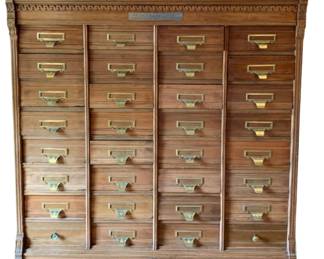 669 - The Shannon Filing Cabinet 48"x46"x18" (Description): Shannon filing cabinet featuring multiple  drawers with brass label holders and pulls.  The cabinet displays decorative carved dentil  molding along the top edge with fluted  column details on the corners. A lower drawer with knob pull is located at the base.  Measures