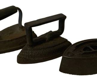 203 - 3 SAD Irons (Description): A lot of three SAD irons. These antique sad  irons, also known as flat irons or smoothing  irons, were historically heated and used for  pressing clothes before the advent of  electric irons. The lot includes three pieces in varying sizes and styles.
