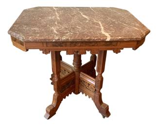 57 - Marble-Top Table 32.5"x33"x24" (Description): Marble-top table featuring an ornately carved  wooden base with decorative turned legs and  detailed fretwork. The table measures 32.5  inches by 33 inches by 24 inches.