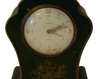 252 - Antique Mantle Clock 5.5"x4.5"x2" (Description): Menes 7 Jewels clock featuring a decorative  case with floral design. Measures 5.5 inches  by 4.5 inches by 2 inches. Used as is electric/electronic/mechanical  item. No guarantee all components, untested.
