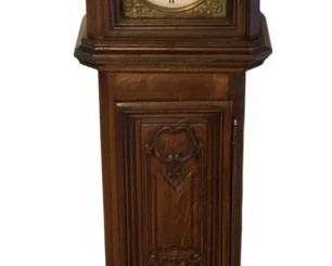 167 - Massol Grandfather Clock 87.5"x21"x13" (Description): Massol grandfather clock featuring a  traditional tall case design with decorative  carved panels on the trunk door. The clock  face displays Roman numerals on a white dial  with ornate brass spandrels and arch decoration. Measures 87.5 inches tall by 21  inches wide by 13 inches deep. Used as is electric/electronic/mechanical  item. No guarantee all components, untested.