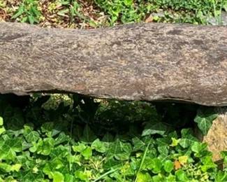 28 - Stone Bench 12"x54"x17" (Description): A rustic stone bench measuring 12 inches high  by 54 inches wide by 17 inches deep. The  bench features a natural stone slab top  supported by stone bases, suitable for garden  or outdoor use.