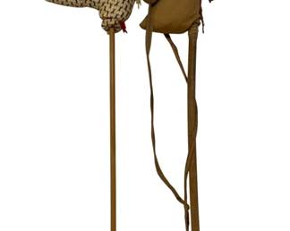 765 - 2 Vintage Stick Hobby Horse Toys 39" long (Description): Two antique horse toys measuring 39 inches  long. These vintage playthings feature  stuffed horse heads mounted on wooden sticks,  classic examples of traditional children's  hobby horses.