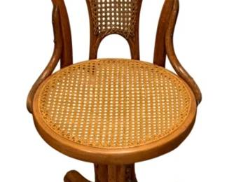 697 - Antique Bentwood Cane Swivel Chair - as is (Description): Antique bentwood swivel chair featuring cane  seat and back. The chair has a distinctive  curved wooden frame with a pedestal base.  Cane on back needs repaired