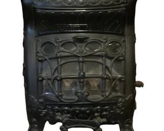 162 - Gas Fireplace 23"x17"x10" (Description): Vintage cast iron gas fireplace featuring  ornate decorative scrollwork and an Art  Nouveau-style design. The stove has a front  glass panel with decorative ironwork overlay,  sits on curved feet, and includes a matching decorative base piece. Measures 23 inches  tall by 17 inches wide by 10 inches deep. Used as is electric/electronic/mechanical  item. No guarantee all components, untested.