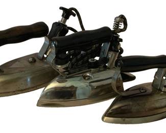 187 - 3 Vintage Irons (Description): A three-piece lot of vintage irons. These  antique pressing irons feature traditional  designs with handles and chrome-finished  bodies, representing various styles from the  early to mid-twentieth century.