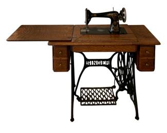 608 - Singer Sewing Machine w/ table 30.5"x36"x18" (Description): S/N G842410 - Antique Singer Treadle Sewing  Machine housed in a wooden cabinet with  decorative cast-iron legs.  Used as is  electric/electronic/mechanical item. No  guarantee all components, untested.