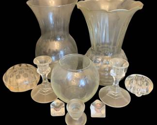 480 - Assorted Glass Items (Description): A lot of assorted glass items including  vases, candlesticks, a bowl, and flower  frogs. The collection features various clear  glass pieces in different shapes and sizes  suitable for home decor and floral arrangements.