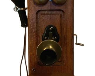 198 - Kellogg Antique Wall Phone 28"x12"x14" (Description): Kellogg antique wall phone featuring a wooden  case with brass bells and mouthpiece, and a  separate earpiece receiver on the side. The  phone includes a hand crank mechanism.  Measures 28 inches high by 12 inches wide by 14 inches deep. Used as is electric/electronic/mechanical  item. No guarantee all components, untested.