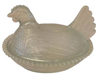 129 - Glass Hen on Nest 5.5"x7"x5.5" (Description): Glass hen on nest covered dish. This  decorative piece features a detailed  hen-shaped lid that rests on a nest-shaped  base with beaded edge detail. Measures 5.5" x  7" x 5.5".