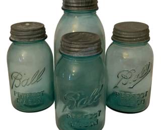 204 - 4 Ball Mason Jars 9" (Description): A collection of four Ball Perfect Mason jars  in the classic blue-green glass. The jars  feature the embossed Ball logo and "Perfect  Mason" lettering. Each jar retains its  original zinc lid. The tallest jar measures 9 inches.