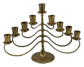 462 - Brass Candleholder 10"x14"x4" (Description): Brass candleholder featuring a tiered design  with multiple candle cups on gracefully  curved arms rising from a decorative round  base. Measures 10 inches by 14 inches by 4  inches.