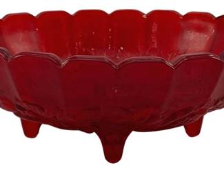 525 - Red Glass Footed Fruit Bowl 4.5"x12"x8.25" (Description): Red glass footed fruit bowl featuring a  scalloped rim and decorative pressed pattern.  The bowl rests on four integral feet.  Measures 4 1/2" x 12" x 8.25".