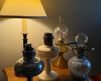 Collection of Four Vintage Oil Lamps: Metal, Milk Glass, Amber Glass, and Floral Electrified
