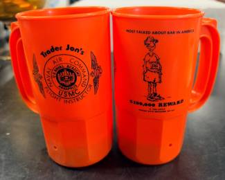 A pair of 1980s Trader Jon’s beer mugs