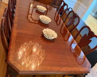 8 seat Dining Room table with 8 chairs (including 2 arm chairs for the ends). The glow is the chandelier reflection. Comes with a leaf extension and table covering pads.