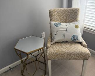 Gold and white animal print chair and brass color, mirrored side table