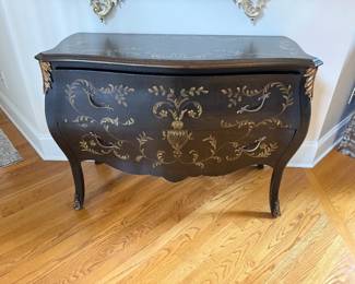 Louis XV or XVI style Black and Gold painted floral Bombe cabinet with ornate gilt scrolling details.