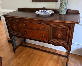 Antique wood buffet sideboard with elegant turned legs.