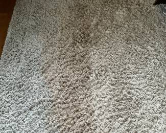 Two 10 x 13 rugs. One used, one brand new in package Cream with brown swirl