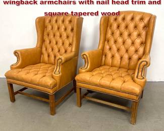 Lot 1753 Pair of Chesterfield style tufted tan wingback armchairs with nail head trim and square tapered wood