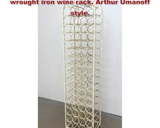 Lot 1522 Tall floor standing arched top wrought iron wine rack. Arthur Umanoff style.