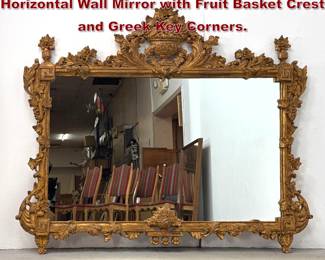 Lot 1747 Large Italian Giltwood Ornate Horizontal Wall Mirror with Fruit Basket Crest and Greek Key Corners. 