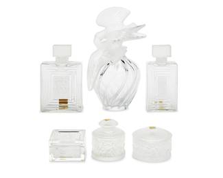 16 Six Lalique glass vanity items Late 20th/early 21st century Each etched: Lalique ® France Comprising a 'L'Air du Temps' factice perfume bottle for Nina Ricci, two 'Duncan' perfume bottles and powder box, and an 'Enfants' perfume bottle and powder box 6 pieces Largest height 12 3/8 in., width 8 1/2 in., depth 7 1/2 in.; shortest height 2 1/2 in., width 3 3/4 in., depth 3 3/4 in. Estimate: $700 - $900