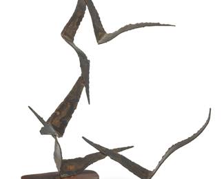 204 A Curtis Jeré style metal sculpture Late 20th century Unmarked Depicting five birds in flight, raised on a wood base Overall height 32 in., width 24 1/2 in., depth 15 1/2 in. approximately Estimate: $400 - $600