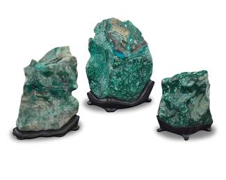 49 Three polished malachite specimens Democratic Republic of the Congo Each exhibiting patterns of overgrowth, raised on a custom-fitted black stand 3 pieces Tallest overall height 11 1/2 in., width 9 in., depth 8 in.; shortest overall height 7 1/2 in., width 6 3/4 in., depth 4 3/4 in. Estimate: $300 - $500
