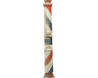 64 A Folk Art painted wood barber pole 20th century On a wood base Overall height 89 in., width 19 1/2 in., depth 19 1/2 in.; diameter of pole 7 3/4 in. Estimate: $600 - $800