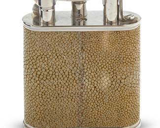 15 A Dunhill shagreen and silver plated table lighter 2000s Marked to underside: Dunhill / MADE IN FRANCE With original fitted box Height 4 in., width 3 3/8 in., depth 1 1/8 in.; box height 3 5/8 in., width 8 3/8 in., depth 8 1/2 in. Estimate: $300 - $500