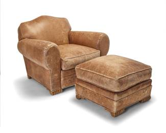 58 An Art Deco style leather club chair and ottoman Late 20th/early 21st century 2 pieces Height of chair 34 1/4 in., width 44 in., depth 39 in.; ottoman height 19 1/2 in. width 26 1/2 in., depth 26 1/2 in. Estimate: $700 - $900