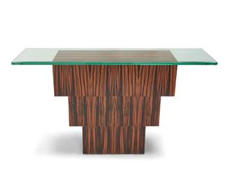 12 A Modern exotic wood console table Early 21st century The beveled glass top supported by three graduated rosewood veneered boxes configured in an inverted pyramid Base height 30 1/2 in., width 36 in., depth 12 in.; glass width 58 in., depth 16 in. Estimate: $400 - $600