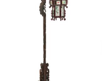 54 A Chinese carved wood and painted glass lantern 20th century Comprising a dragon-form cantilever stand carved with cloud accents, married to a later carved wood and interior-painted glass lantern depicting birds, electrified Stand height 71 3/4 in., width 17 3/4 in., depth 12 1/2 in. Estimate: $500 - $700