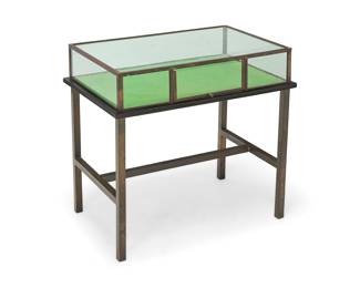 207 An industrial style metal vitrine table Late 20th century Glass etched: NV Hardglas Zoetermeer With glazed case and hinged front door, velvet-lined wood display surface, and metal frame base Overall height 26 3/4 in., width 28 1/4 in., depth 18 3/4 in. Estimate: $400 - $600
