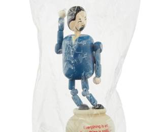 120 After Ai Weiwei (b. 1957) "Everything is Art, Everything is Politics" figure, 2015 From the edition of unknown size Printed with title and attribution Painted wood, in original packaging Height 5 3/8 in., width 1 7/8 in., depth 1 7/8 in. Estimate: $300 - $500