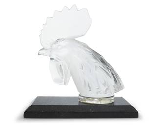 17 A Lalique glass 'Tête de Coq' bookend Late 20th/early 21st century Originally designed 1928 as a mascot Etched: Lalique ® France Raised on a granite base Glass height 7 1/4 in., width 6 1/2 in., depth 3 1/8 in.; overall height 8 in., width 7 3/4 in. depth 4 in. Estimate: $300 - $400