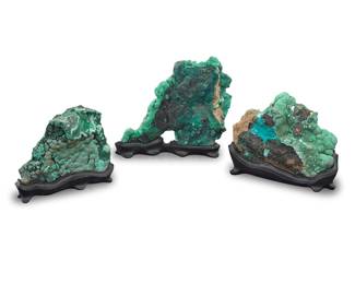 51 Three malachite specimens Democratic Republic of the Congo The largest with botryoidal growth, bull's eyes, and chatoyancy effect on the reverse side, each raised on a custom-fitted black stand 3 pieces Tallest overall height 10 in., width 11 3/4 in., depth 4 in.; shortest overall height 7 3/8 in., width 9 in., depth 3 3/4 in. Estimate: $300 - $500