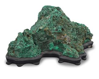 50 A malachite specimen Democratic Republic of the Congo In the style of a scholar stone, raised on a custom fitted black stand Overall height 7 3/4 in., width 16 in., depth 11 1/4 in. Estimate: $300 - $500