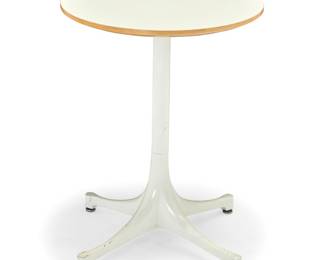 43 George Nelson (1908-1986) A pedestal side table for Herman Miller, 1956-1964 Designed 1954 With applied metal factory label The painted aluminum base with laminate-veneered MDF top, raised on 'Dome of Silence' glides Height 22 1/4 in., overall diameter 19 1/2 in., tabletop diameter 17 in. Estimate: $300 - $500