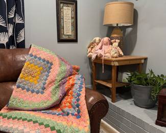 Hand stitched quilt, leather loveseat, lamp, end table, fabric bunnies.