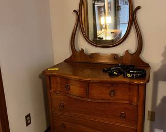 Antique serpentine dresser with mirror