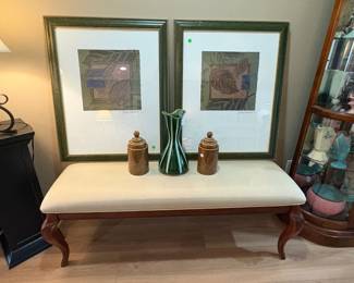 Sweet simple ivory fabric bench supporting a great pair of signed prints and MCM goodies.