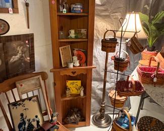 One of a pair of corner shelf units. Baskets and antiques.