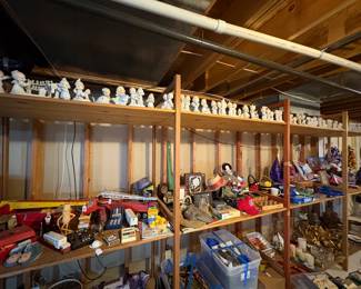 The top row of shelves is completely full of Precious Moment figurines.